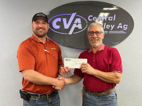 CVA’s Michael Bayer delivers check to member-owner Bruce Pfeifer from Humphrey, Nebraska.