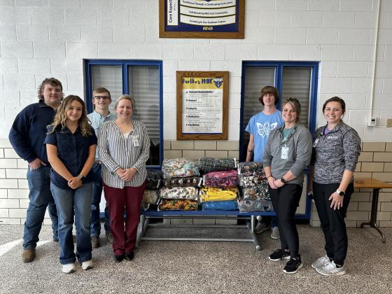 Pike Valley High students donate handmade fleece blankets to Solomon Valley Hospice.