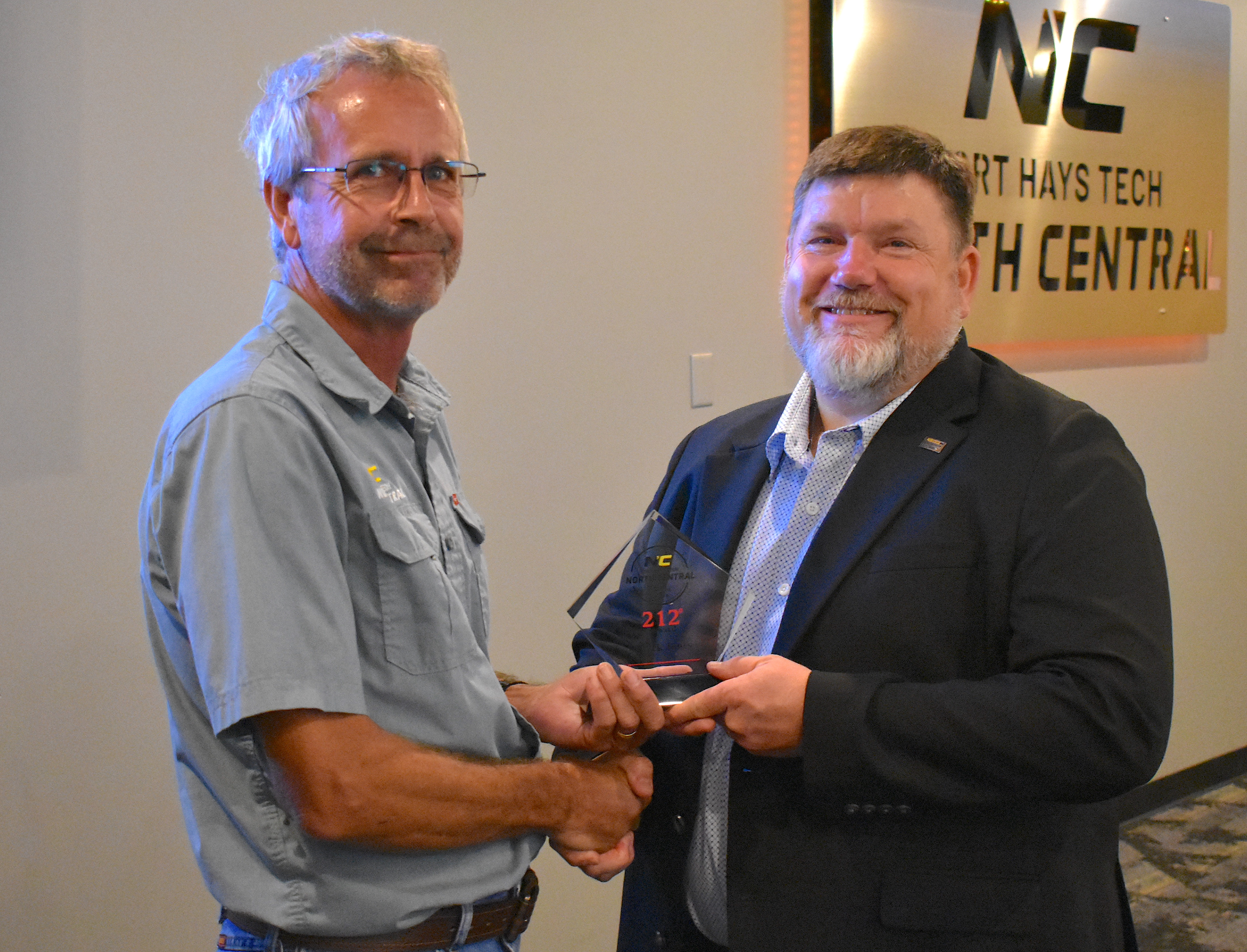 Mark Jones (left) receives the 212° Award from Eric Burks (right).