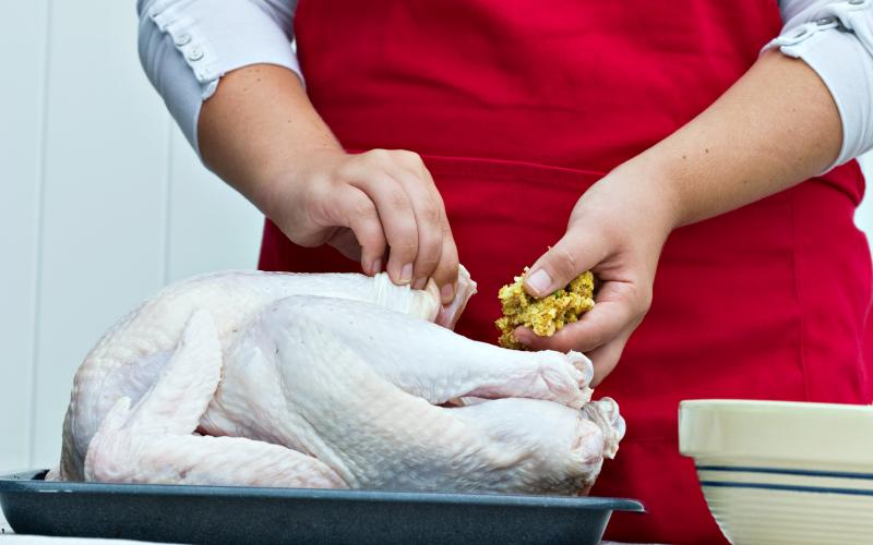 Stuffing a large turkey for a holiday dinner