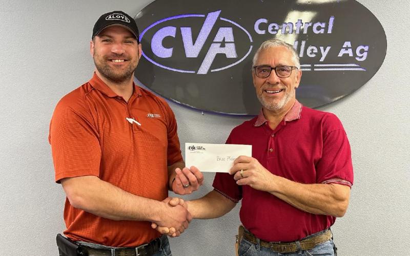 CVA’s Michael Bayer delivers check to member-owner Bruce Pfeifer from Humphrey, Nebraska.