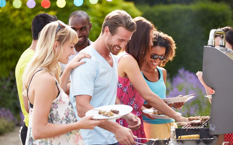 Group Of Friends Having Outdoor Barbeque At Home