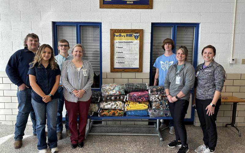 Pike Valley High students donate handmade fleece blankets to Solomon Valley Hospice.