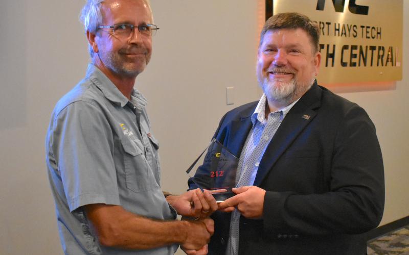 Mark Jones (left) receives the 212° Award from Eric Burks (right).